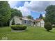 Charming single-Gathering home with a lush green lawn, mature trees, and a two-car garage at 6006 Buell Ln, Indianapolis, IN 46254