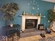 Stylish fireplace with decor, an electric guitar, and plants creating a cozy atmosphere at 6006 Buell Ln, Indianapolis, IN 46254