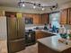 Well-lit kitchen with wood cabinets, stainless steel appliances, and a tile backsplash at 6006 Buell Ln, Indianapolis, IN 46254