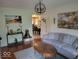Cozy living room with hardwood floors, comfortable seating, and decorative artwork at 6006 Buell Ln, Indianapolis, IN 46254