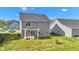 The backyard features a covered patio area and lush green lawn at 6305 Norwich Dr, Brownsburg, IN 46112