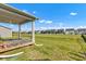 Backyard with covered patio and view of the neighboring houses in the community at 6305 Norwich Dr, Brownsburg, IN 46112