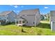 The backyard features a covered patio area and lush green lawn at 6305 Norwich Dr, Brownsburg, IN 46112