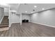 Finished basement area with wood-look flooring and stairs to the main level at 6305 Norwich Dr, Brownsburg, IN 46112
