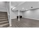 Unfinished basement space with gray walls, vinyl floors, and a staircase at 6305 Norwich Dr, Brownsburg, IN 46112