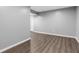 Bright basement area features wood-look floors and neutral gray walls at 6305 Norwich Dr, Brownsburg, IN 46112