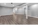 Spacious basement featuring wood-look floors, ample lighting, and neutral gray walls at 6305 Norwich Dr, Brownsburg, IN 46112