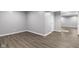 Basement with wood-look floors, neutral walls and white trim at 6305 Norwich Dr, Brownsburg, IN 46112