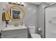 Bathroom featuring a modern vanity, round mirror, and a walk-in shower at 6305 Norwich Dr, Brownsburg, IN 46112