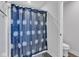 Bathroom featuring a shower with a blue floral curtain, plus a toilet and gray flooring at 6305 Norwich Dr, Brownsburg, IN 46112