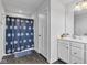 Bathroom featuring a shower with a blue floral curtain, plus a vanity and gray flooring at 6305 Norwich Dr, Brownsburg, IN 46112