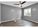 Cozy bedroom boasts a ceiling fan, natural light, and durable wood-look flooring at 6305 Norwich Dr, Brownsburg, IN 46112