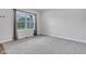 Empty bedroom featuring gray carpet, white walls, and natural light from a side window at 6305 Norwich Dr, Brownsburg, IN 46112
