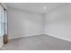 Empty bedroom featuring gray carpet, white walls, and natural light from a side window at 6305 Norwich Dr, Brownsburg, IN 46112