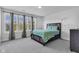 Sunlit bedroom with large windows, neutral tones, and a comfortable bed at 6305 Norwich Dr, Brownsburg, IN 46112