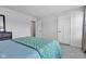 Bright bedroom featuring neutral walls, carpet and door in addition to blue patterned bedding on bed at 6305 Norwich Dr, Brownsburg, IN 46112