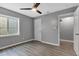 Bedroom with window, wood-look floors, ceiling fan and ample closet space at 6305 Norwich Dr, Brownsburg, IN 46112