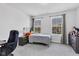 Bedroom featuring neutral walls, carpet, a desk and two windows that let in natural light and a view of the neighborhood at 6305 Norwich Dr, Brownsburg, IN 46112