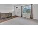 Inviting entryway with stylish console table, wood-look floors and a bright view from the large window at 6305 Norwich Dr, Brownsburg, IN 46112
