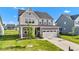 Charming two-story home with a well-manicured lawn and attached two-car garage at 6305 Norwich Dr, Brownsburg, IN 46112