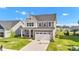 Charming two-story home with a well-manicured lawn and attached two-car garage at 6305 Norwich Dr, Brownsburg, IN 46112