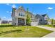 Beautiful two-story home with manicured lawn, a two car garage, and modern gray and white color scheme at 6305 Norwich Dr, Brownsburg, IN 46112