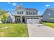 Charming two-story home with a well-maintained lawn, a two car garage, and a classic covered front porch at 6305 Norwich Dr, Brownsburg, IN 46112