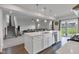 Open concept kitchen with quartz island, stainless appliances, and view to the living area at 6305 Norwich Dr, Brownsburg, IN 46112