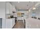 Modern kitchen with quartz island, stainless steel appliances, gas range, and sleek white cabinetry at 6305 Norwich Dr, Brownsburg, IN 46112