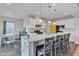 Modern kitchen with a large island, pendant lighting, stainless steel appliances, and an adjacent dining area at 6305 Norwich Dr, Brownsburg, IN 46112