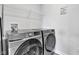 Well-lit laundry room featuring a modern Samsung washer and dryer set with wire shelving at 6305 Norwich Dr, Brownsburg, IN 46112