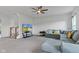 Inviting living room with a modern ceiling fan, plush sofa, TV, and staircase to the second floor at 6305 Norwich Dr, Brownsburg, IN 46112