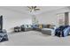 Spacious living room with plush sectional sofa, modern ceiling fan, and comfortable massage chair at 6305 Norwich Dr, Brownsburg, IN 46112