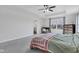 Bright main bedroom featuring a ceiling fan, neutral carpet, and nice natural light at 6305 Norwich Dr, Brownsburg, IN 46112