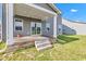 Covered wooden patio with steps down to the green backyard and view of the homes at 6305 Norwich Dr, Brownsburg, IN 46112