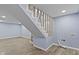 Finished basement with light blue walls and wood-look floors, showing the utility connections at 641 E 33Rd St, Indianapolis, IN 46205