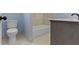 Bathroom featuring a bathtub, toilet, gray countertop, and white flooring at 641 E 33Rd St, Indianapolis, IN 46205