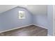 Bedroom with wood floors, blue walls, white trim and a window at 641 E 33Rd St, Indianapolis, IN 46205