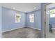 Bedroom with wood floors, two windows and an ensuite bathroom with a door ajar at 641 E 33Rd St, Indianapolis, IN 46205