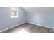 Bedroom with wood floors, blue walls, white trim and a window at 641 E 33Rd St, Indianapolis, IN 46205