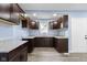 Bright kitchen featuring dark cabinets, gray countertop, vinyl flooring, and a white door at 641 E 33Rd St, Indianapolis, IN 46205