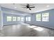 Bright living room featuring wood floors, a ceiling fan, and lots of natural light from multiple windows at 641 E 33Rd St, Indianapolis, IN 46205