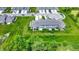 Community aerial view showcasing well-manicured lawns, gray townhomes, and green trees at 6429 Yuma Ct, Whitestown, IN 46075