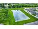 Scenic aerial view of community featuring a pond with fountain and green spaces at 6429 Yuma Ct, Whitestown, IN 46075