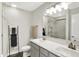 Modern bathroom with dual sinks, a large mirror, and a glass-enclosed shower at 6429 Yuma Ct, Whitestown, IN 46075