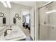 Stylish bathroom with double sinks, a view of the bedroom, and a glass-enclosed shower at 6429 Yuma Ct, Whitestown, IN 46075