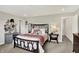 Spacious bedroom features an ornate bed frame with decorative accents and neutral tones at 6429 Yuma Ct, Whitestown, IN 46075