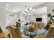 Bright dining area featuring a glass-top table with seating and modern lighting fixtures at 6429 Yuma Ct, Whitestown, IN 46075