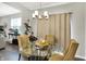 Elegant dining room featuring a glass table, stylish chairs, and modern lighting fixture at 6429 Yuma Ct, Whitestown, IN 46075