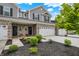 Charming townhome exterior with brick and siding, well-kept landscaping, and attached two-car garage at 6429 Yuma Ct, Whitestown, IN 46075